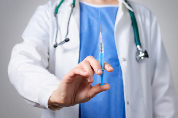 Female doctor with syringe