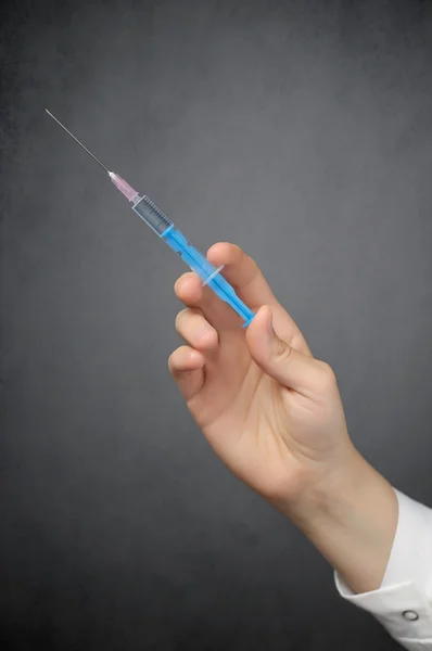 Hand of a doctor with syringe — Stock Photo, Image