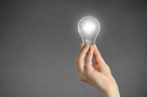 Hand with light bulb — Stock Photo, Image