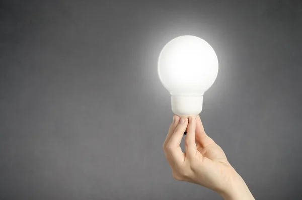 Hand with light bulb — Stock Photo, Image