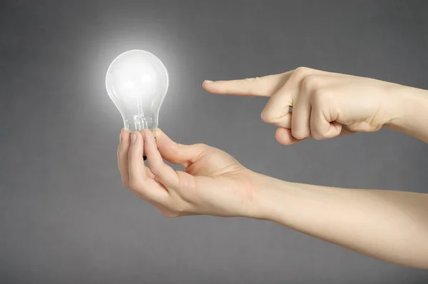 Hand with light bulb — Stock Photo, Image