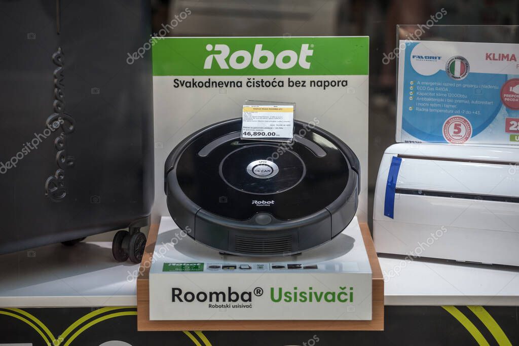 BELGRADE, SERBIA - JUNE 8, 2019: iRobot logo in front of a roomba vacuum cleaer for sale in Belgrade, Roomba is a robot vacuum cleaner developed by a technology company, iRobot