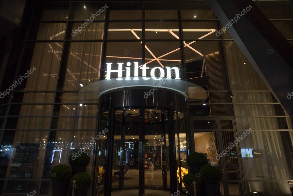BELGRADE, SERBIA - NOVEMBER 12, 2018: Hilton logo on the entrance their newly opened hotel of Belgrade, during the evening. Hilton is one of the biggest brands of luxury hotels