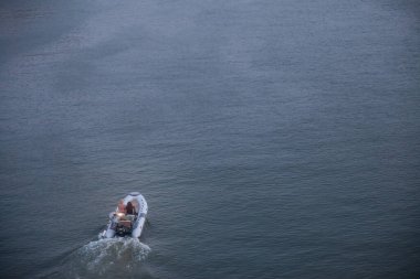 BELGRADE, SERBIA - AUGUST 13, 2018: Two persons riding an inflatable dinghy, a pneumatic boat on sava river in Belgrade, Serbia, during a warm summer afternoon ideal for water sports