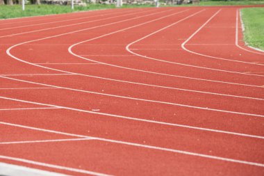 Selective blur on the curve on a running track, an athletics field used for athletism competition, like sprint, or running race, and for olympic competitive events.