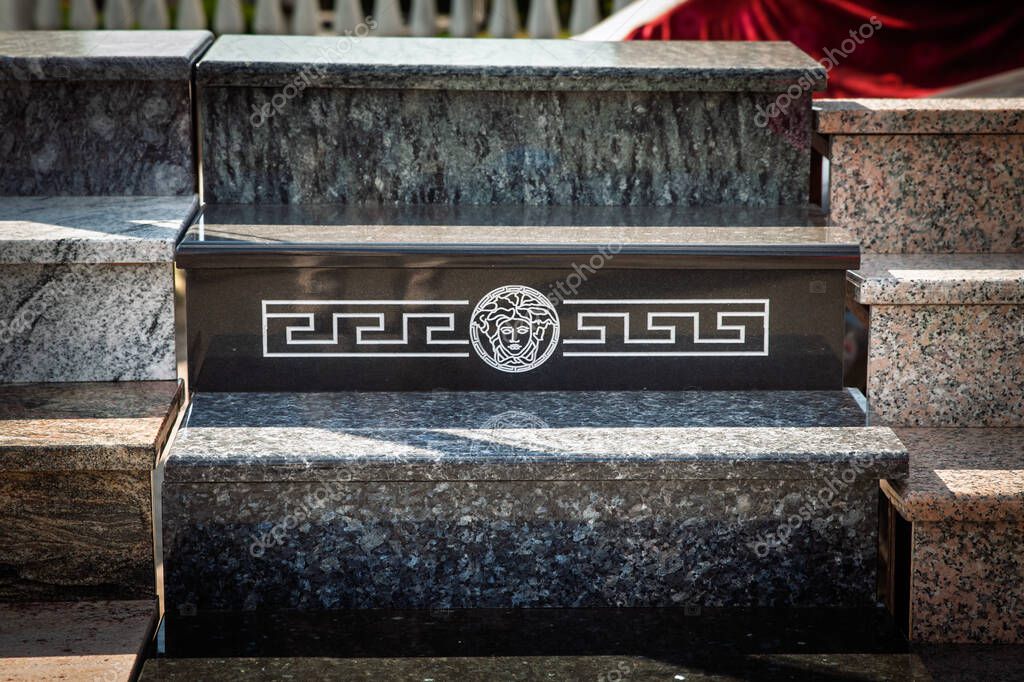 OBRENOVAC, SERBIA - JULY 12, 2025: Marble stair blocks at an outdoor market in Serbia, featuring a Greek key motif and a Medusa head resembling a Versace logo, suggesting fake unauthorized brand use.