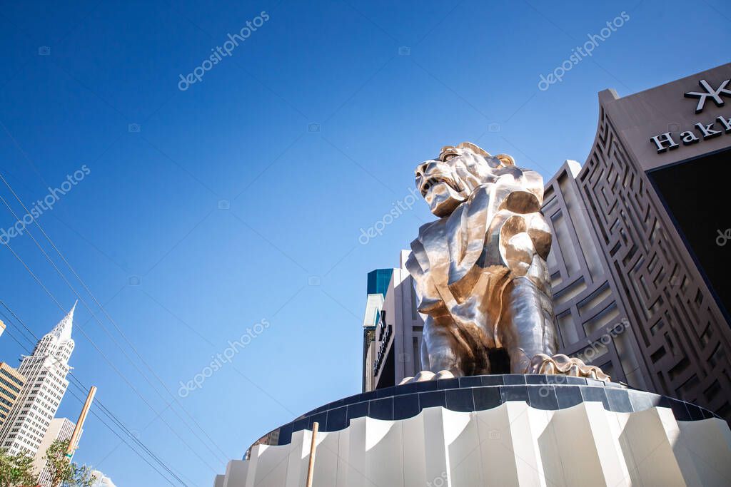 LAS VEGAS - AUGUST 19, 2024: The bronze Leo the Lion sculpture stands at the entrance of MGM Grand on the Las Vegas Strip. The towering statue and hotel facade represent a famous casino landmark.