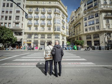 VALENCIA, İSPA - 6 Nisan 2025: 2 yaşlı adam, kıdemli, Valencia 'da yaya geçidinde birlikte durarak, karşıya geçmek için bekliyorlar, İspanyol toplumu yaşlanıyor.