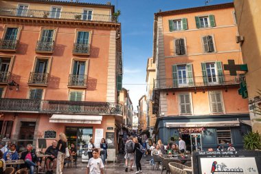 HYERES, FRANCE - SEPTEMBER 27, 2025: Fransız Rivierası 'ndaki Vieux Hyeres' te canlı bir sahne, Pastel binalar, kafe terasları ve tarihi merkezdeki dükkanlar arasında kalabalık. İnsanlar gezinir, yemek yer, alışveriş yapar..