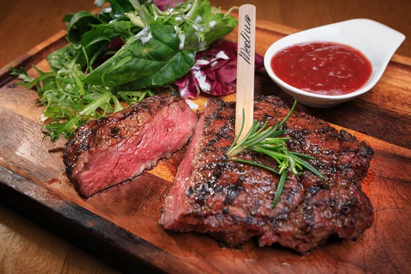 Meat steak on the wooden board — Stock Photo, Image