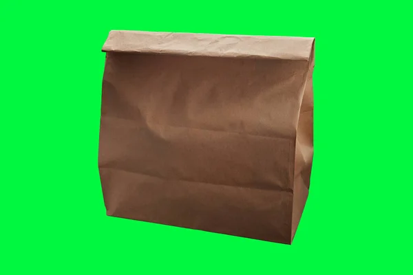 Yeşil Arkaplanlı Kahverengi Tek Kullanımlık Kağıt Yemek Torbası — Stok fotoğraf