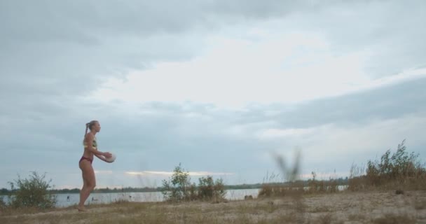 Beach volleyball player woman is training a serve on court at nature, slow motion full length shot — Stock Video