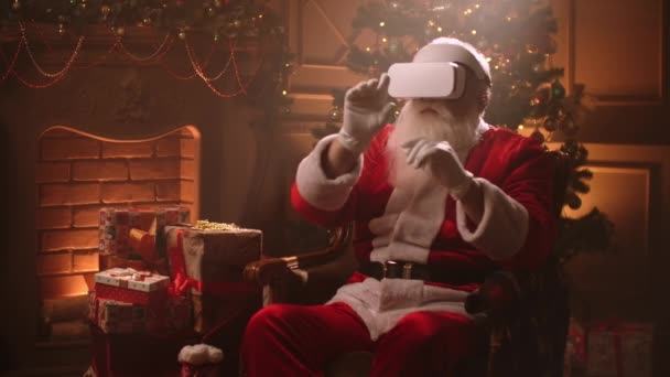 Samtida jultomten använder modern högteknologisk gadget 3D huvud monterad display i sitt rum på julen semester — Stockvideo