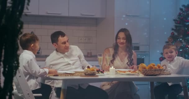 Large caucasian family celebrating thanksgiving day, chatting at dinner party table while eating roasted turkey and salads - celebration concept — Stock Video