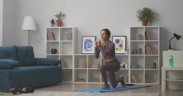 Huka och hoppa ung kvinna utbildning hemma, träning på själv-isolering och lockdown, gå ner i vikt — Stockvideo