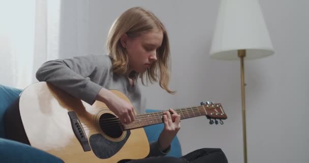 Een jong meisje speelt prachtig grappige muziek op de gitaar. — Stockvideo