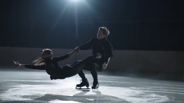 Treino de patinação artística dupla, desportistas fortes está segurando seu parceiro feminino e girando na pista de gelo, pessoas desportivas profissionais — Vídeo de Stock