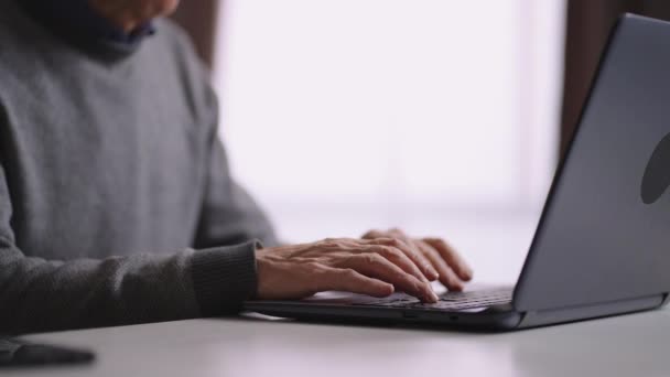Anciano está trabajando con el ordenador portátil en casa, primer plano de las manos masculinas en el teclado, jubilado está navegando por Internet — Vídeos de Stock