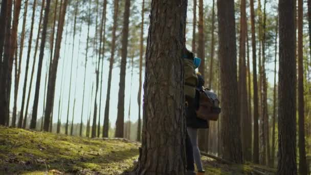 Una joven pareja de hombres y mujeres negros caminan por el bosque durante un viaje al bosque con mochilas en cámara lenta. Dos africanos caminan por el bosque con mochilas durante el turismo — Vídeos de Stock