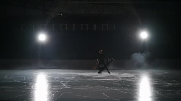 Slow motion: Cinematic shot of young female artistic figure skater is performing a womans single skating choreography on ice piink before start of a competition. Begrip vrijheid — Stockvideo