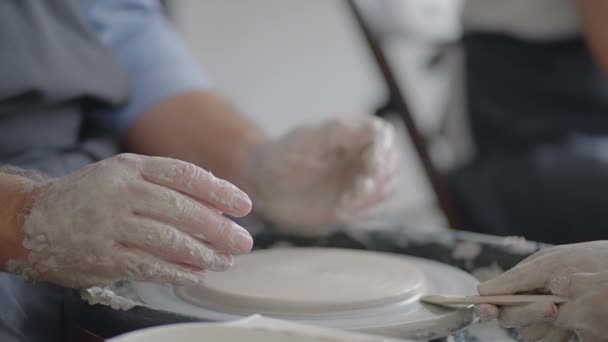 Close-up of a male master working on a potters wheel close-up in slow motion — Stock Video