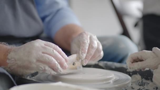 Close-up of a male master working on a potters wheel close-up in slow motion — Stock Video