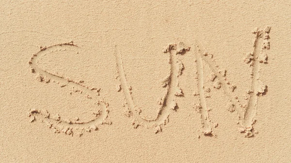 Word "sun" printed on the sand background — Stock Photo, Image