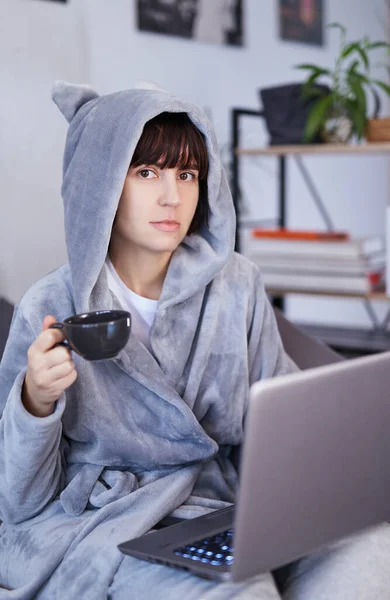 가운을 침대에 랩탑으로 일하는 아름다운 갈색의 여성이 집에서 노트북으로 일하는 — 스톡 사진