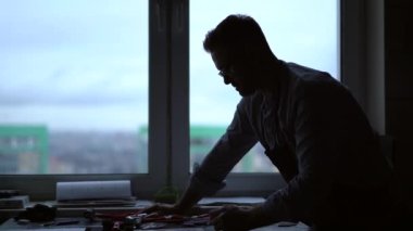 Bir stüdyoda çalışan, sanatçı ya da profesyonel endüstriyel tasarımcının silueti. Profesyonel bir imalatçının çalışma yeri. 4k görüntü