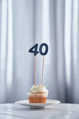 Tasty anniversary creamy cupcake with number 40 forty clipart