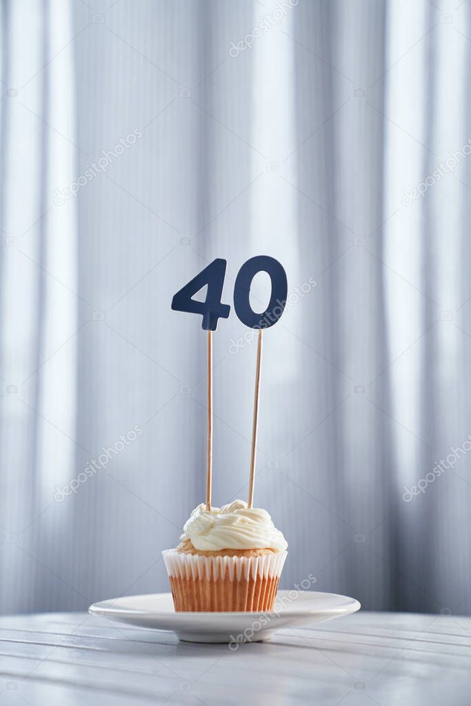 Tasty anniversary creamy cupcake with number 40 forty