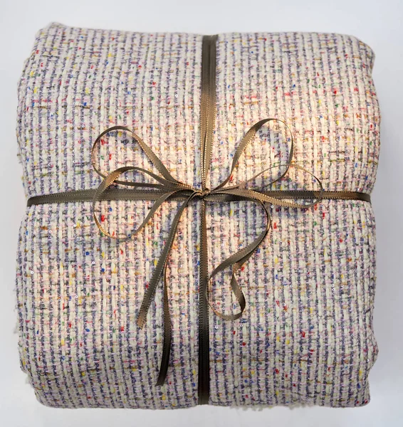 Textile cloth blanket folded as a gift with ribbon — Stock Photo, Image