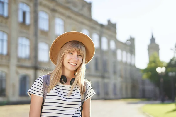 European college or university student girl in hat at campus