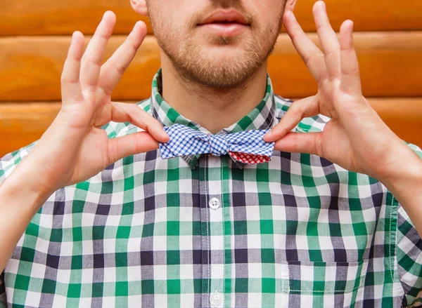 Young business man correcting his retro bowtie — Stock Photo, Image