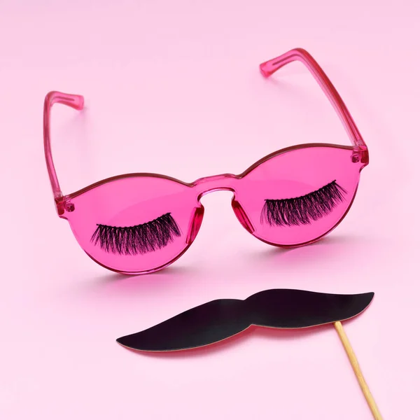 Pink glasses with eyelashes and mustache close up