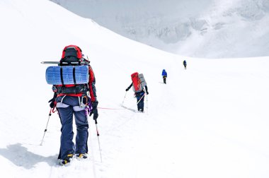 Group of  climbers reaching the summit clipart