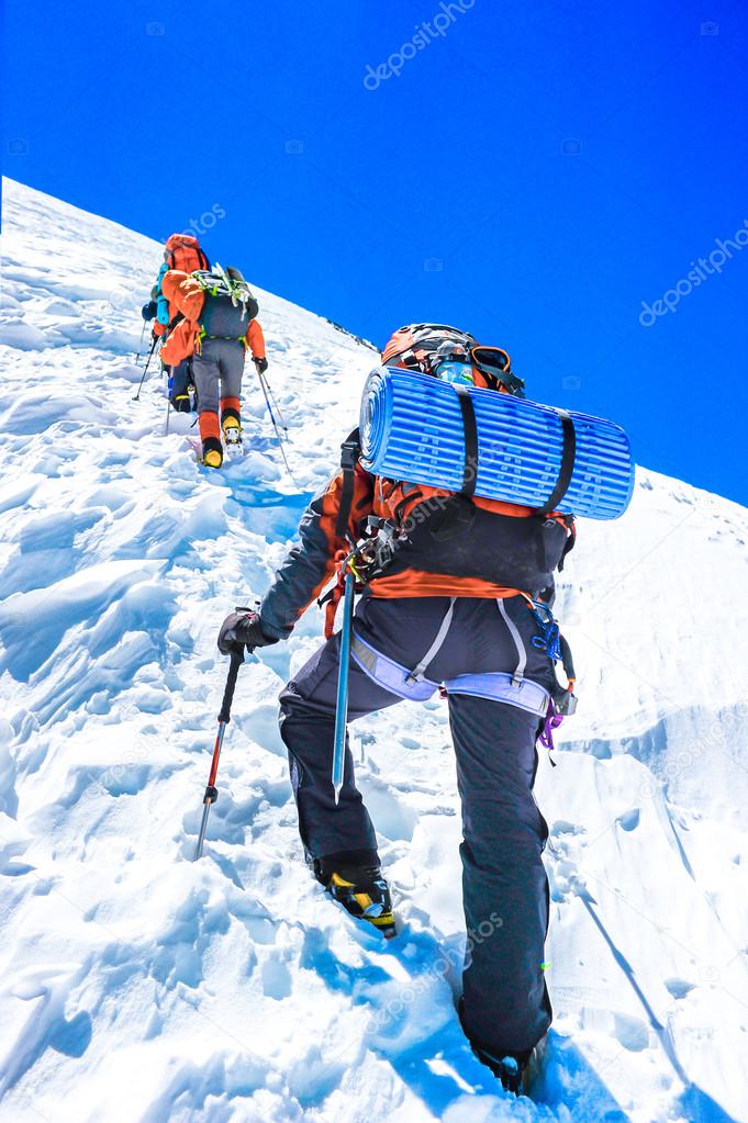 Group of climbers reaching the summit. Extreme sport concept