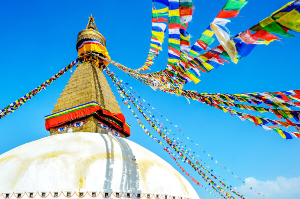 Bodhnath stupa in kathmandu with buddha eyes and prayer flags