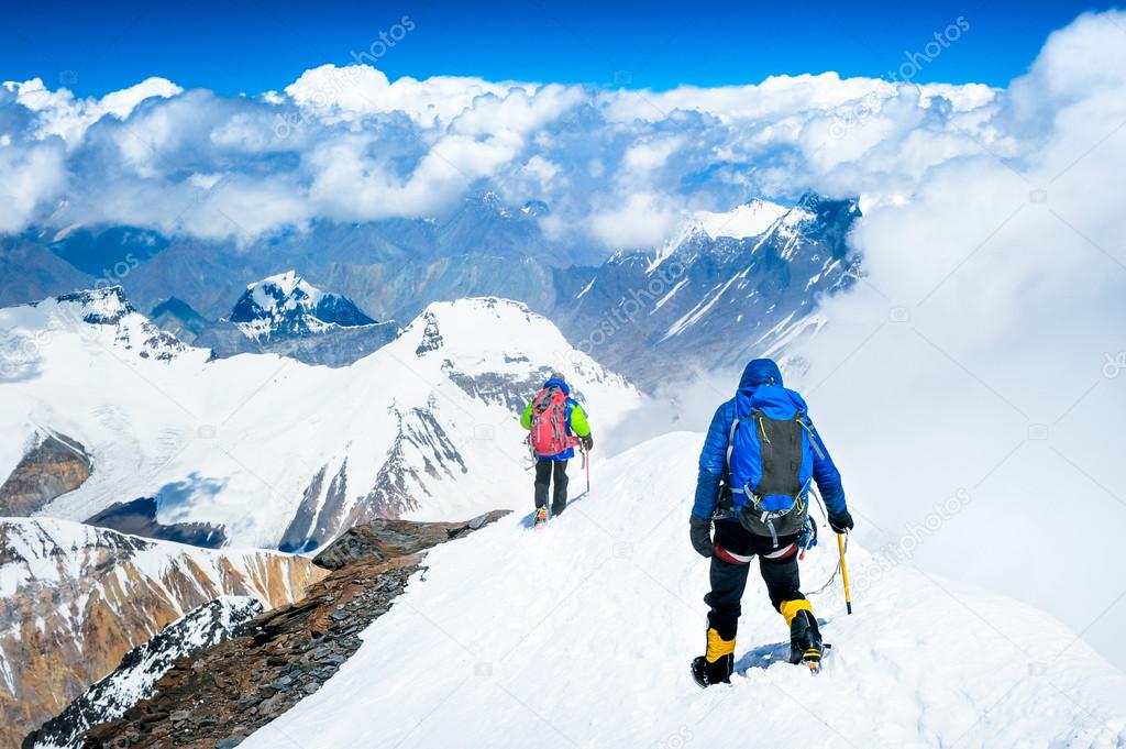 Group of climbers reaching the summit