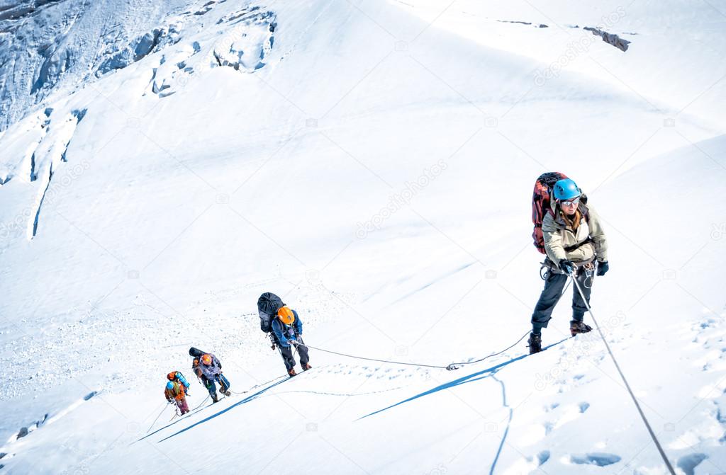 Group of climbers reaching the summit. Extreme sport concept