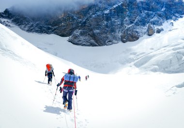 Group of climbers reaching the summit. clipart