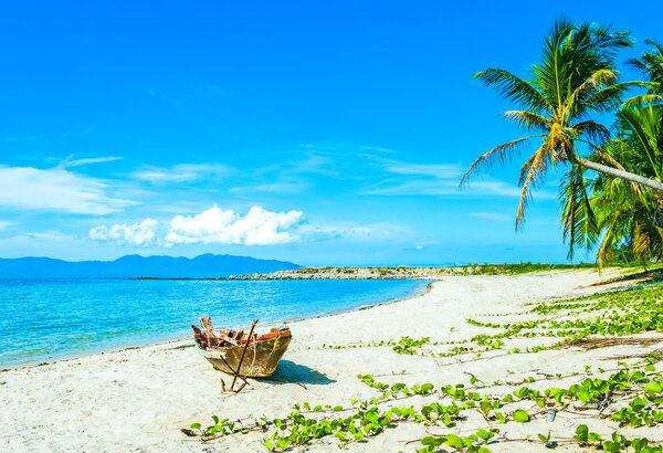 Old fisherman boat with anchor on the beach