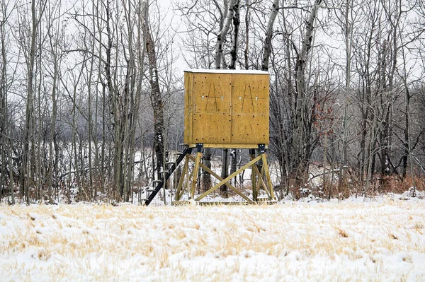 A closed down hunting blind in the winter