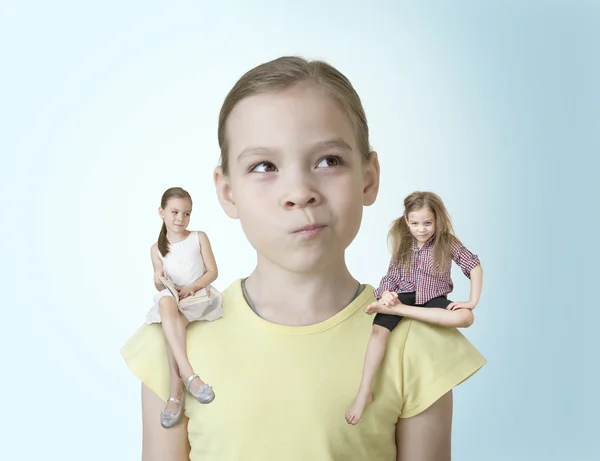 Little girl makes a choice between two of his characters — Stock Photo, Image