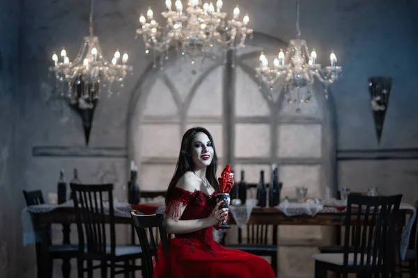 Vampiro fêmea sanguinário em vestido vermelho. Interior medieval — Fotografia de Stock