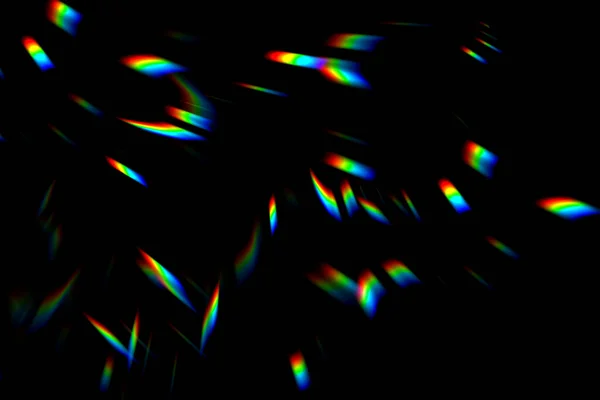 Abstract blurred colorful lens flare bokeh on black — Stock Photo, Image