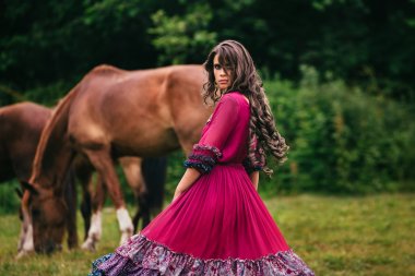 Beautiful gypsy in violet dress