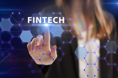 İş, Teknoloji, İnternet ve ağ konsepti. Genç işadamı geleceğin sanal ekranı üzerinde çalışıyor ve Fintech yazısını görüyor.