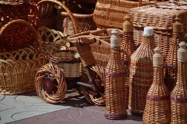 Willow baskets, bottles and bicycles and boxes — Stock Photo, Image