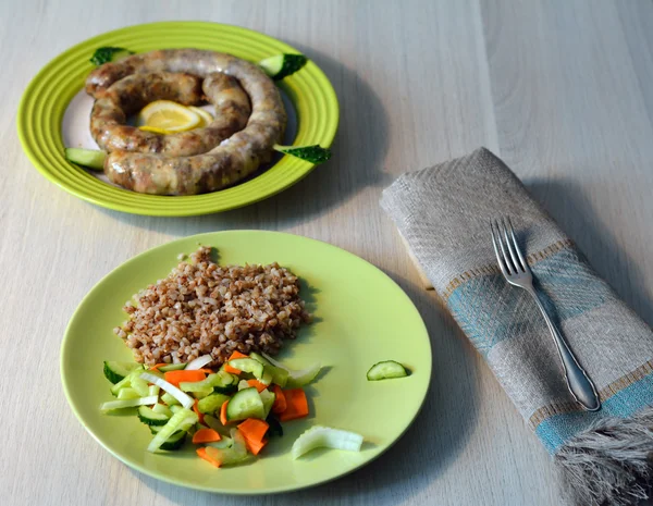 Meal of homemade pork sausage, salad and buckwheat — Stock Photo, Image